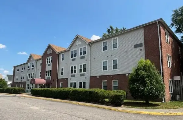 a view of a building with a yard