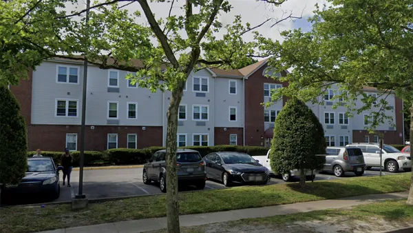 a car parked in front of a brick house