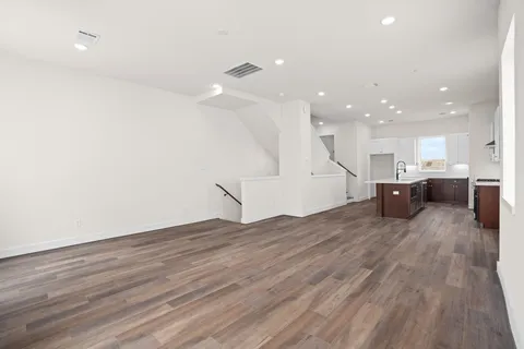 a view of kitchen and hall with wooden floor