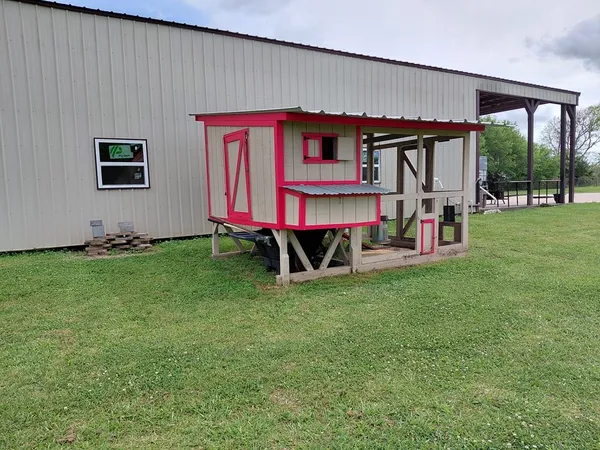 a living room with furniture kitchen view and a wooden floor