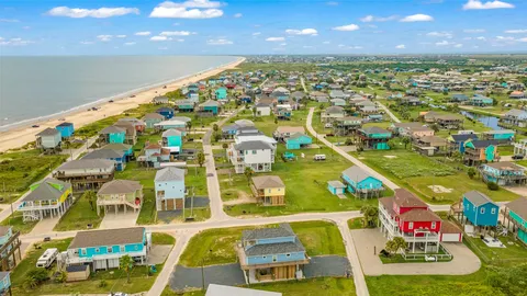 an aerial view of residential houses with outdoor space and swimming pool