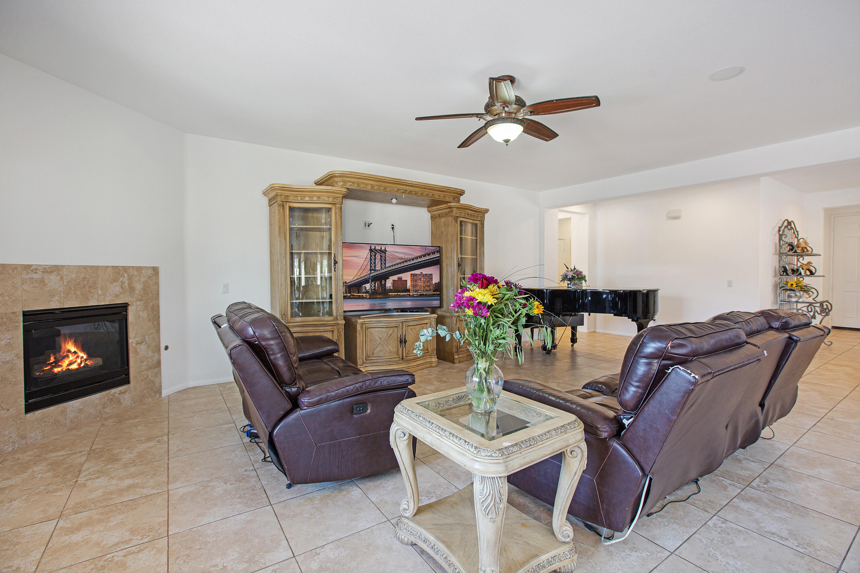 35922 Raphael Drive Palm Desert, CA 92211 - Photo 16 of 33 a living room with furniture a fireplace and a flat screen tv