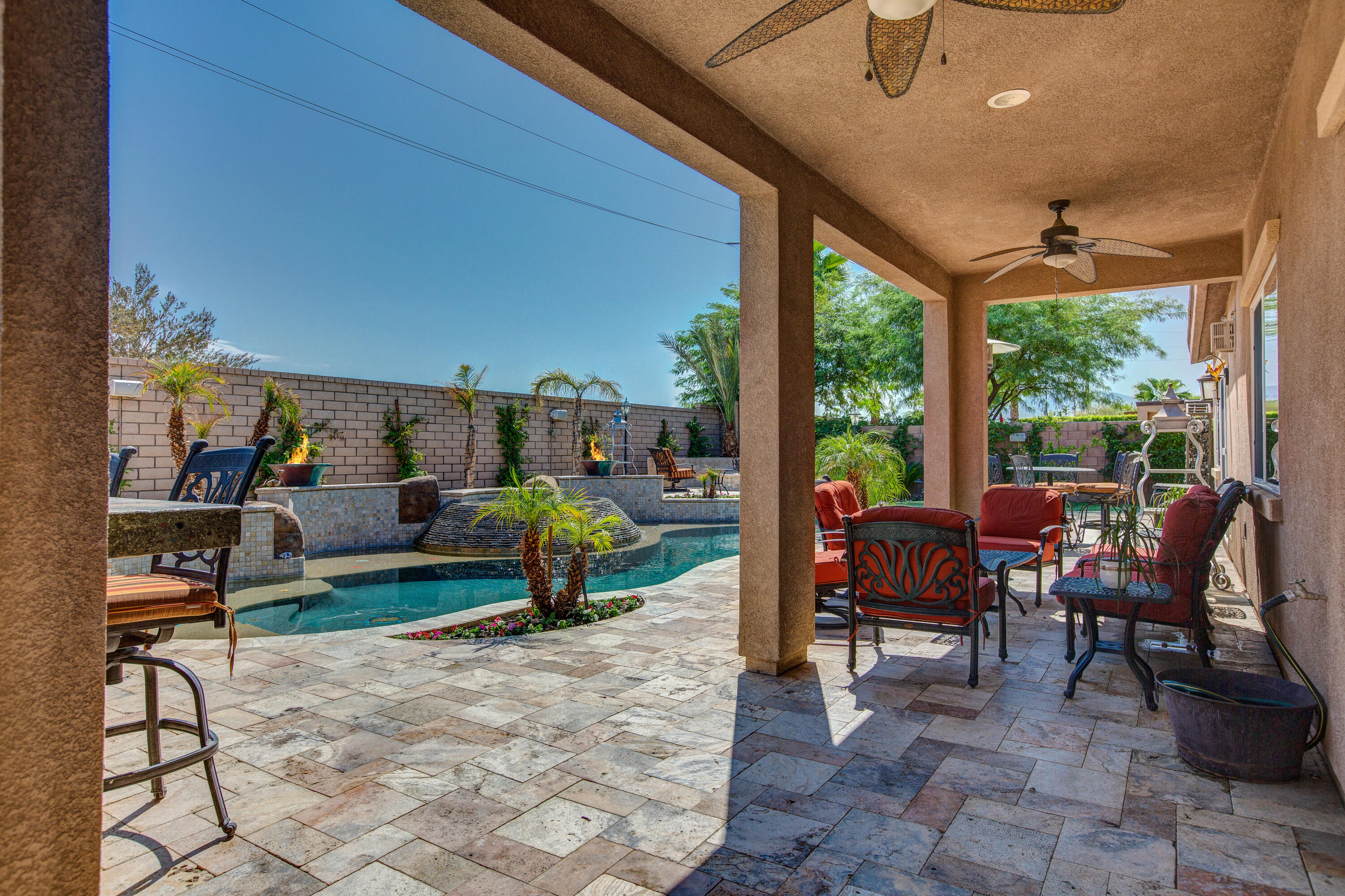 35922 Raphael Drive Palm Desert, CA 92211 - Photo 3 of 33 a view of a patio with table and chairs potted plants with floor to ceiling window