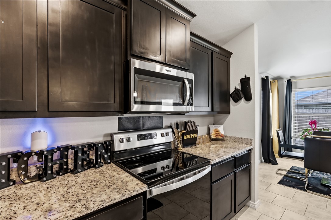 2009 Chief Street Bryan, TX 77807 - Photo 10 of 27 a kitchen with a stove and a microwave