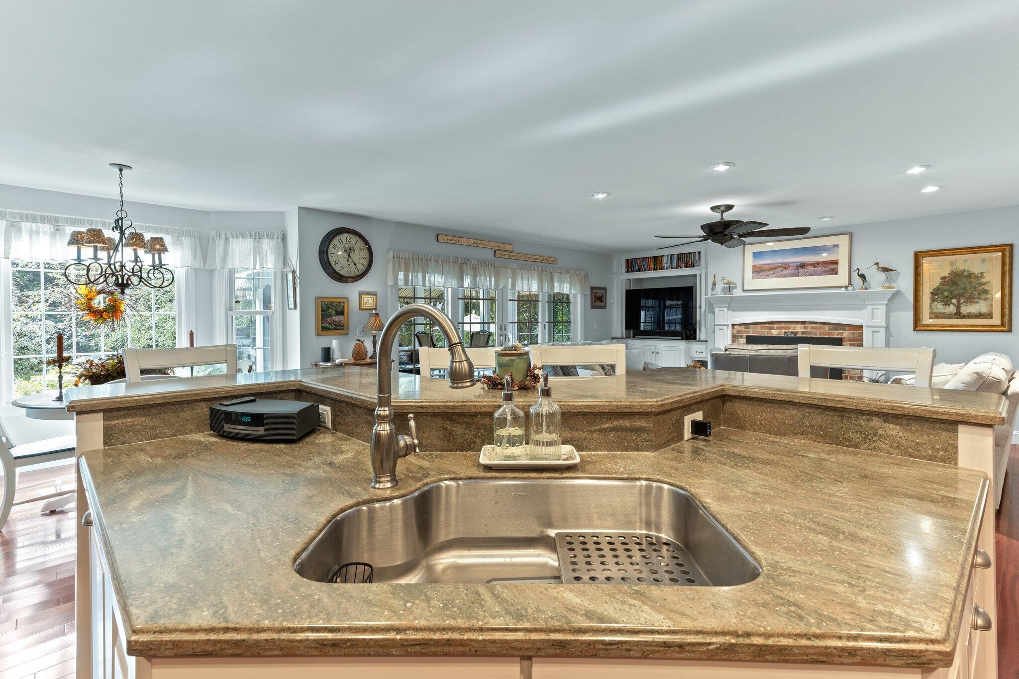 9 Briar Spring Road Orleans, MA 02653 - Photo 17 of 65 a kitchen with a sink a counter top space and living room view