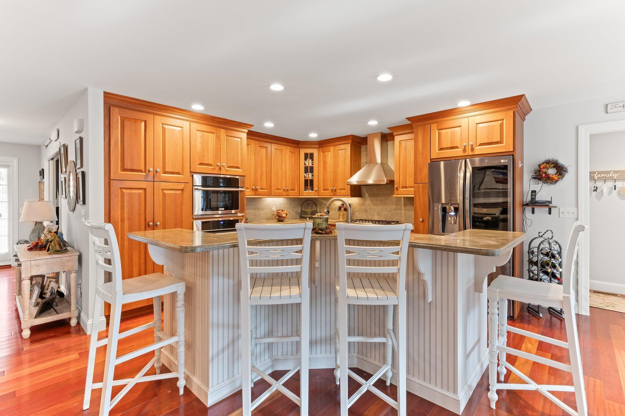 9 Briar Spring Road Orleans, MA 02653 - Photo 19 of 65 a kitchen with stainless steel appliances granite countertop a stove a sink and a refrigerator
