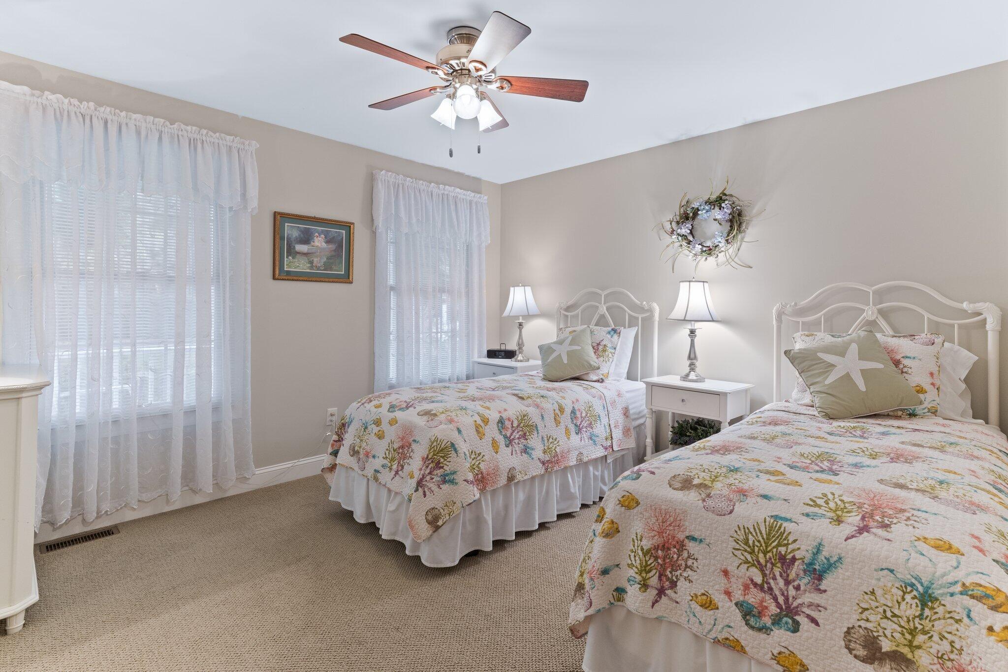 9 Briar Spring Road Orleans, MA 02653 - Photo 33 of 65 a bedroom with two beds and a chandelier