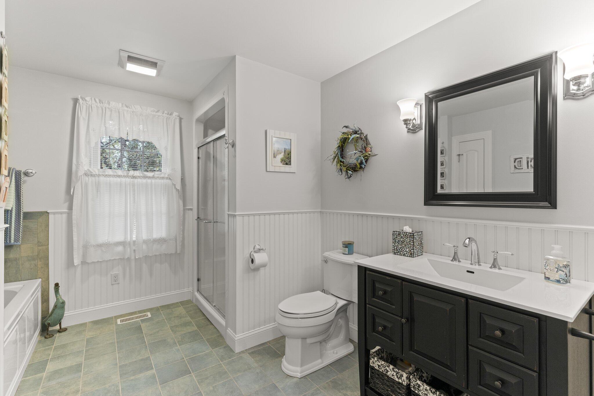 9 Briar Spring Road Orleans, MA 02653 - Photo 34 of 65 a bathroom with a toilet sink a shower and a mirror
