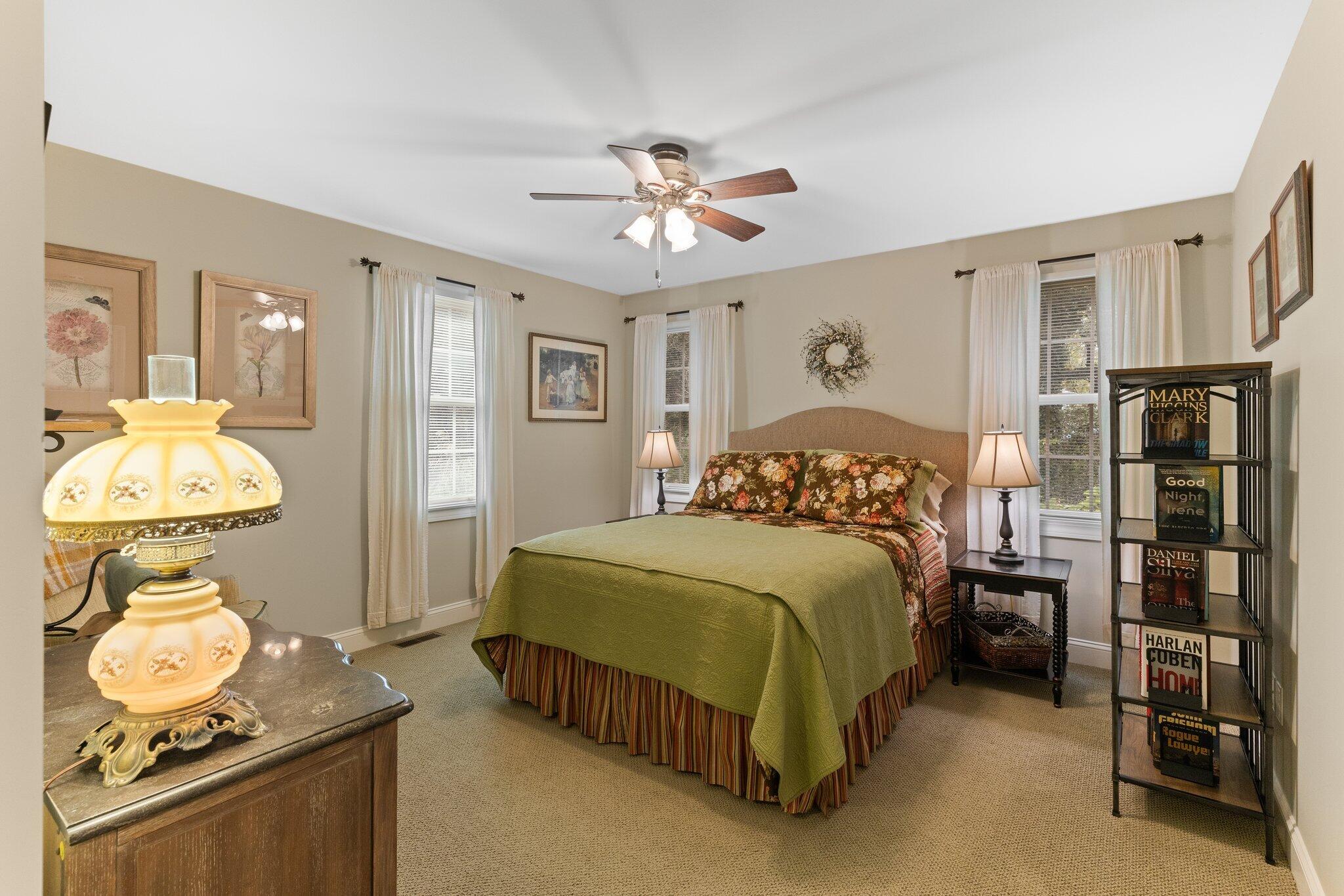 9 Briar Spring Road Orleans, MA 02653 - Photo 36 of 65 a bedroom with a bed and a chandelier