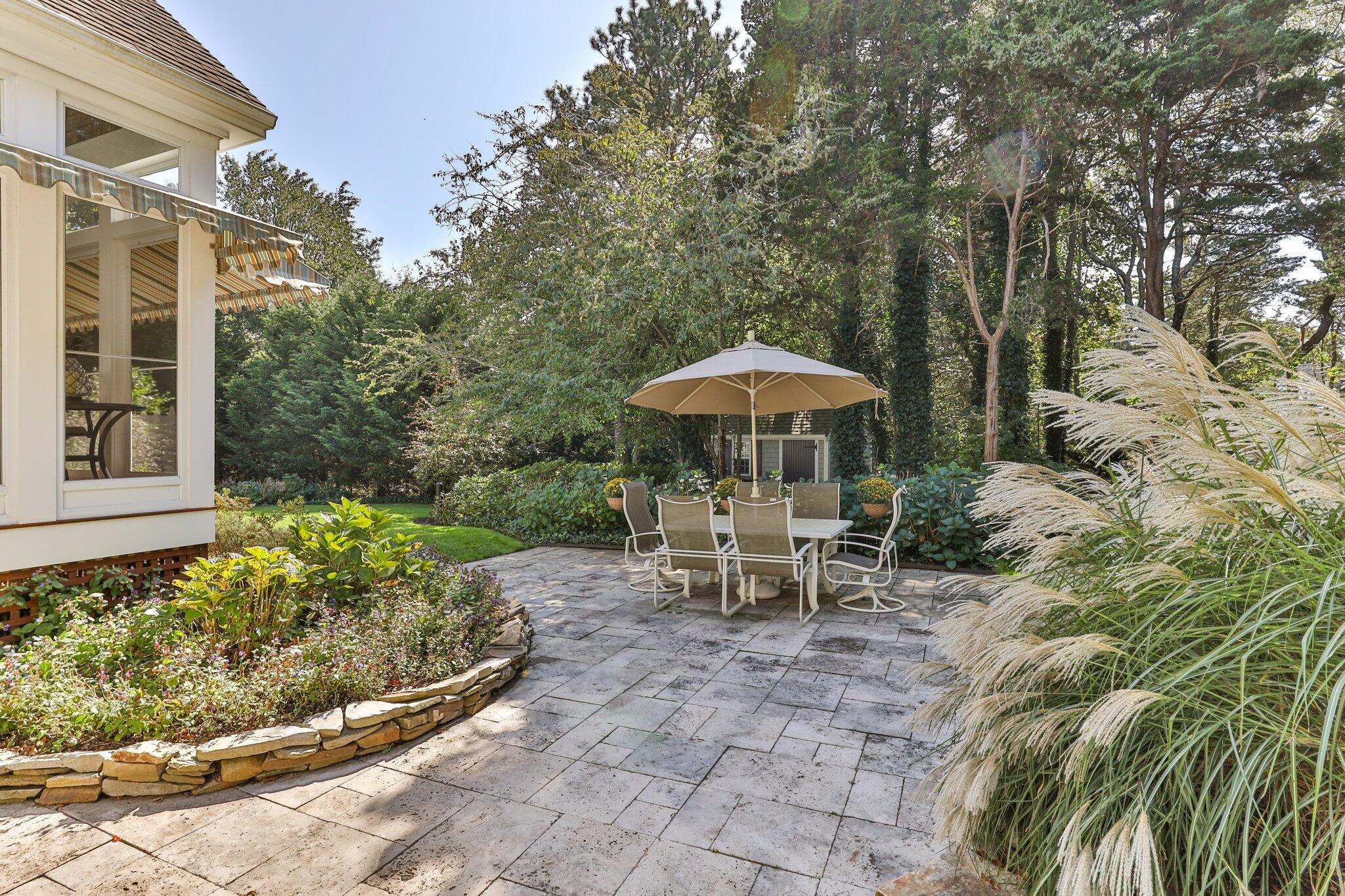 9 Briar Spring Road Orleans, MA 02653 - Photo 49 of 65 a view of a table and chairs under an umbrella in the patio
