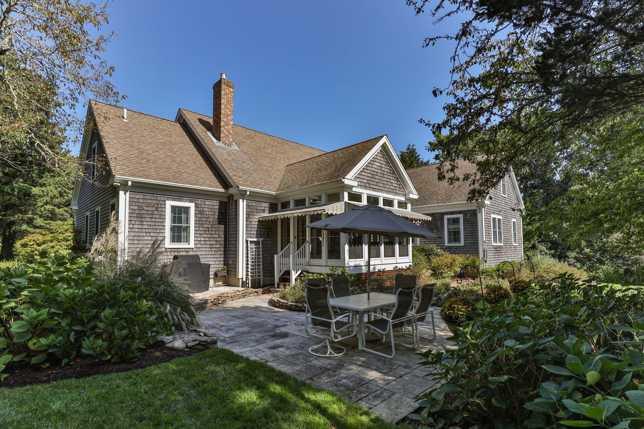 9 Briar Spring Road Orleans, MA 02653 - Photo 51 of 65 a front view of a house with a garden and sitting area