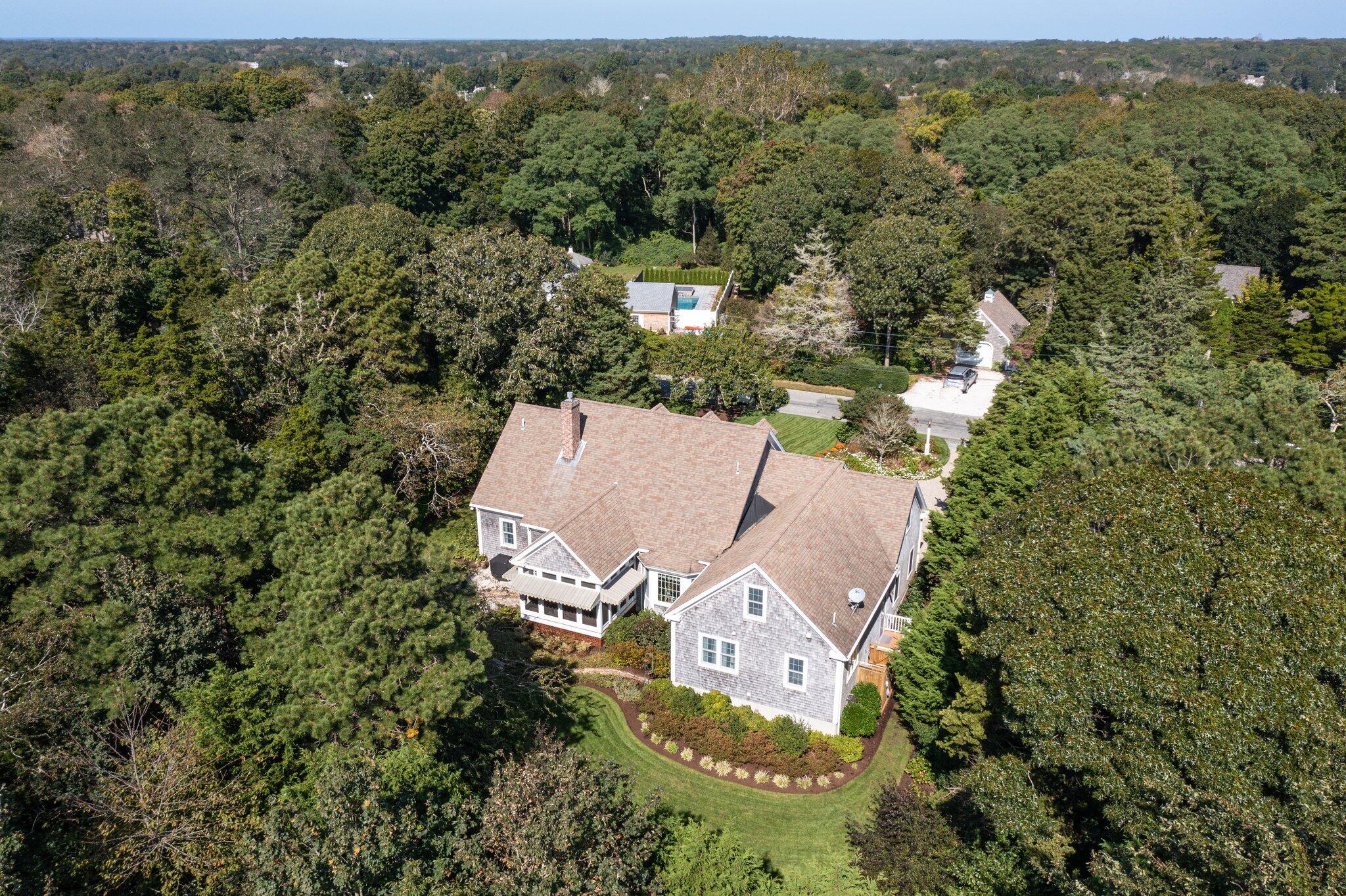9 Briar Spring Road Orleans, MA 02653 - Photo 57 of 65 an aerial view of a house with a yard and outdoor seating