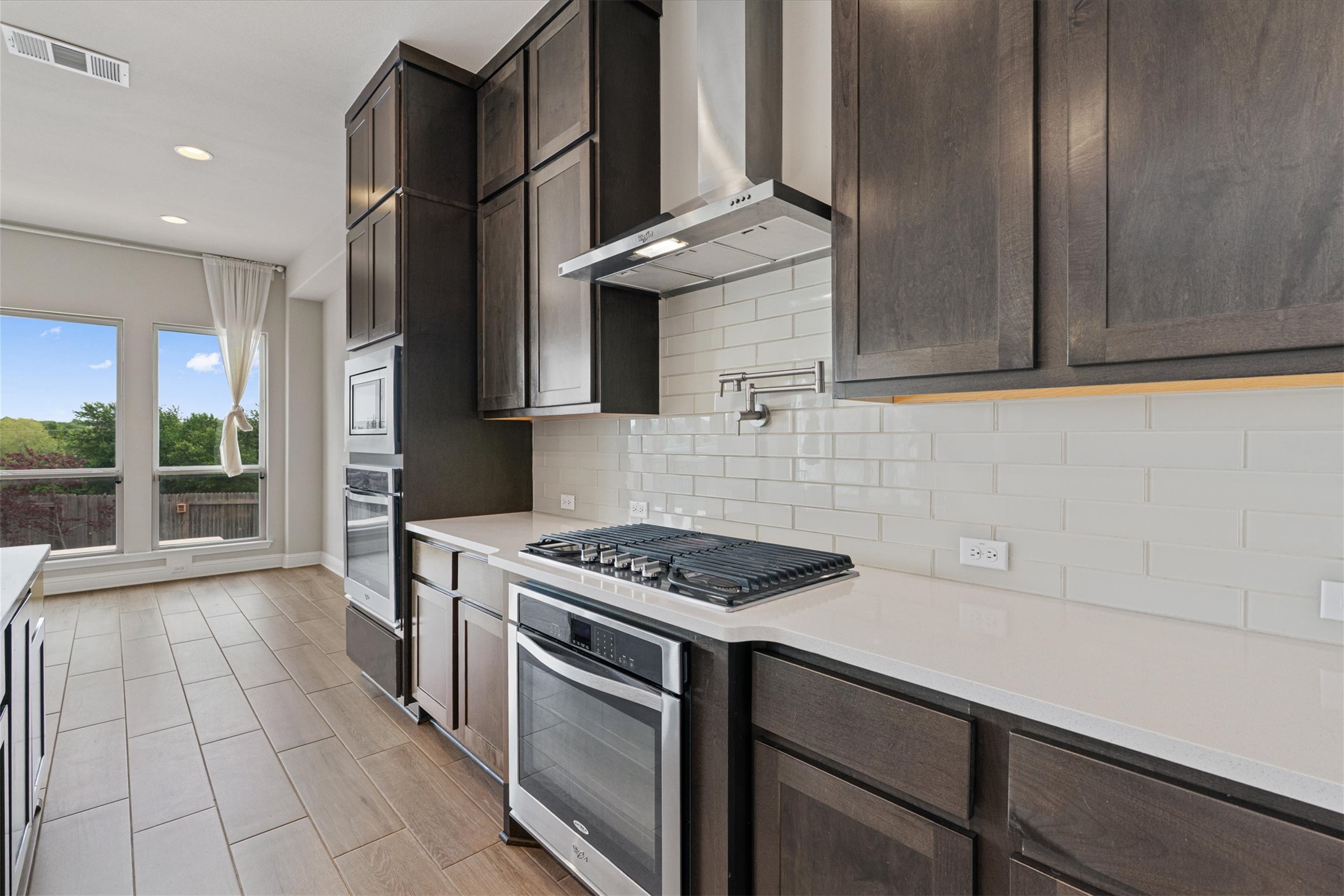 622 Cheyenne Lane Cedar Park, TX 78613 - Photo 10 of 40 Extra-tall espresso cabinetry provides more storage than you’ll know what to do with, paired with stainless appliances and a built-in reverse osmosis system