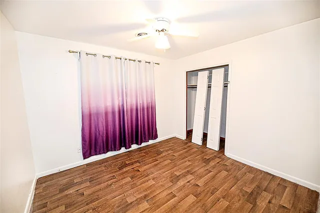 a view of a room with wooden floor