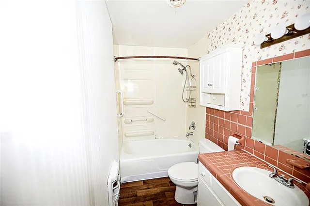 a view of a utility room with wooden floor