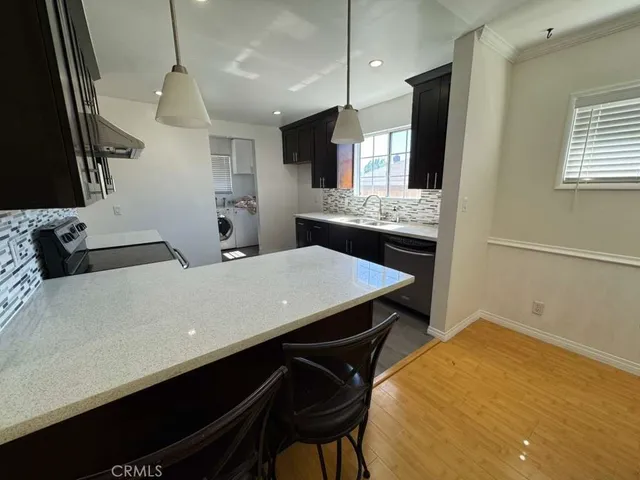a kitchen with a table chairs and a stove