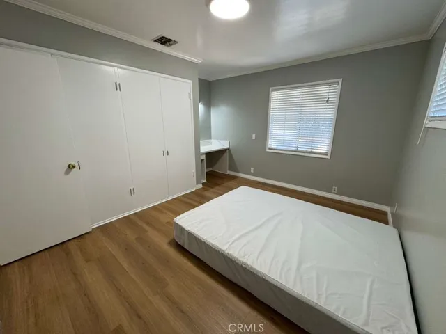 a bed sitting in a bedroom next to a window