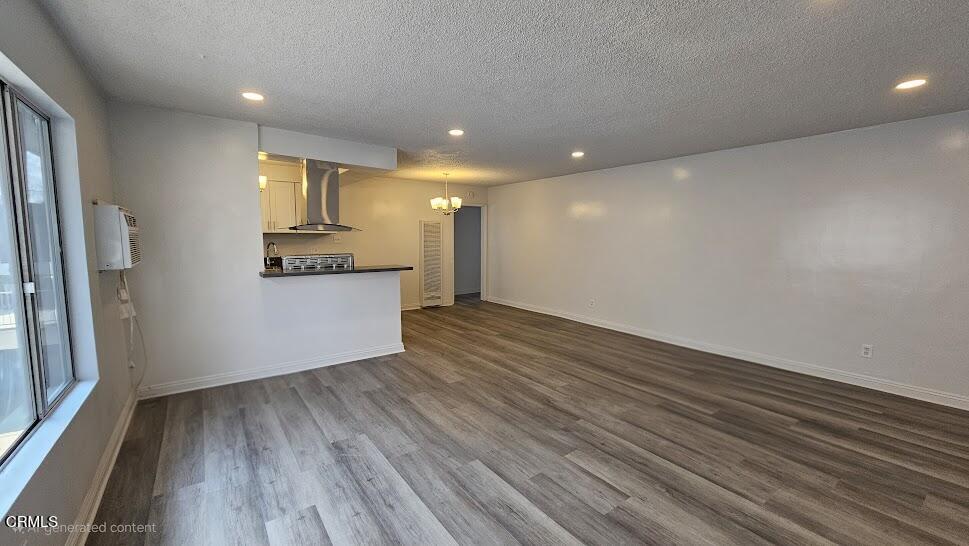 a view of a kitchen with wooden floor and a refrigerator