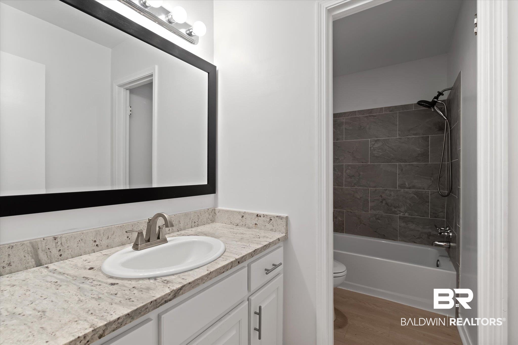 1008 Mcneil Avenue Mobile, AL 36609 - Photo 12 of 20 Full bathroom with hardwood / wood-style floors, vanity, toilet, and tiled shower / bath combo