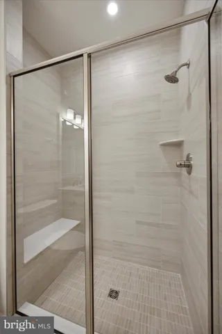 a bathroom with a glass shower door