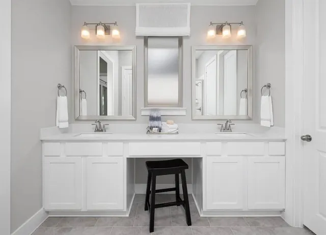 a bathroom with a sink double vanity and a mirror