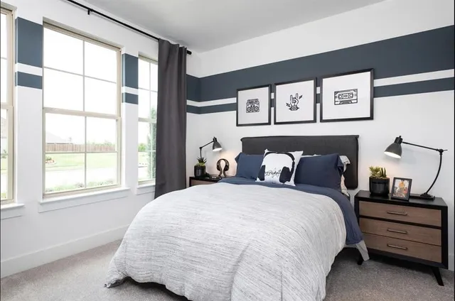 a bed sitting in a bedroom next to a window