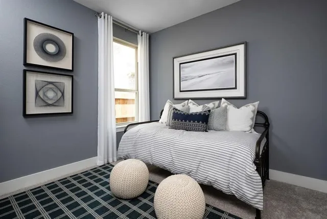 a bedroom with furniture and a window