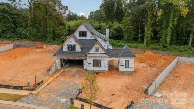 an aerial view of a house with yard swimming pool and outdoor seating
