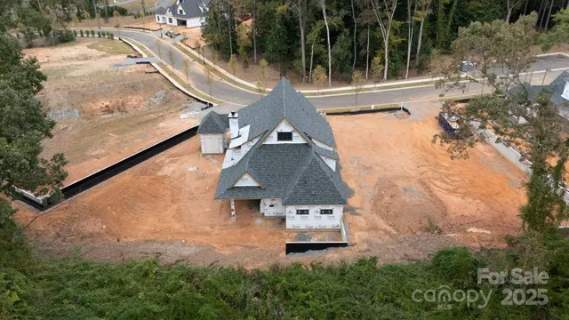 an aerial view of a house with swimming pool garden and patio