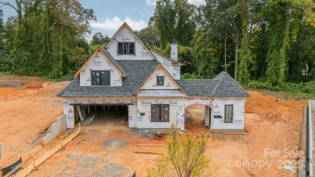 an aerial view of a house with a yard and wooden fence