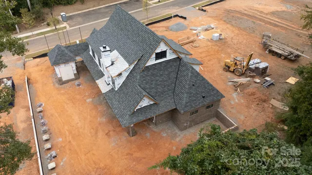 an aerial view of a house with a yard and trees