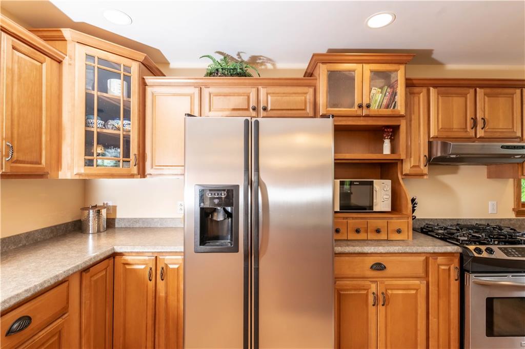 50 Merrick Street Indiana, PA 15701 - Photo 14 of 48 a kitchen with stainless steel appliances granite countertop a refrigerator a stove and a sink with wooden floor