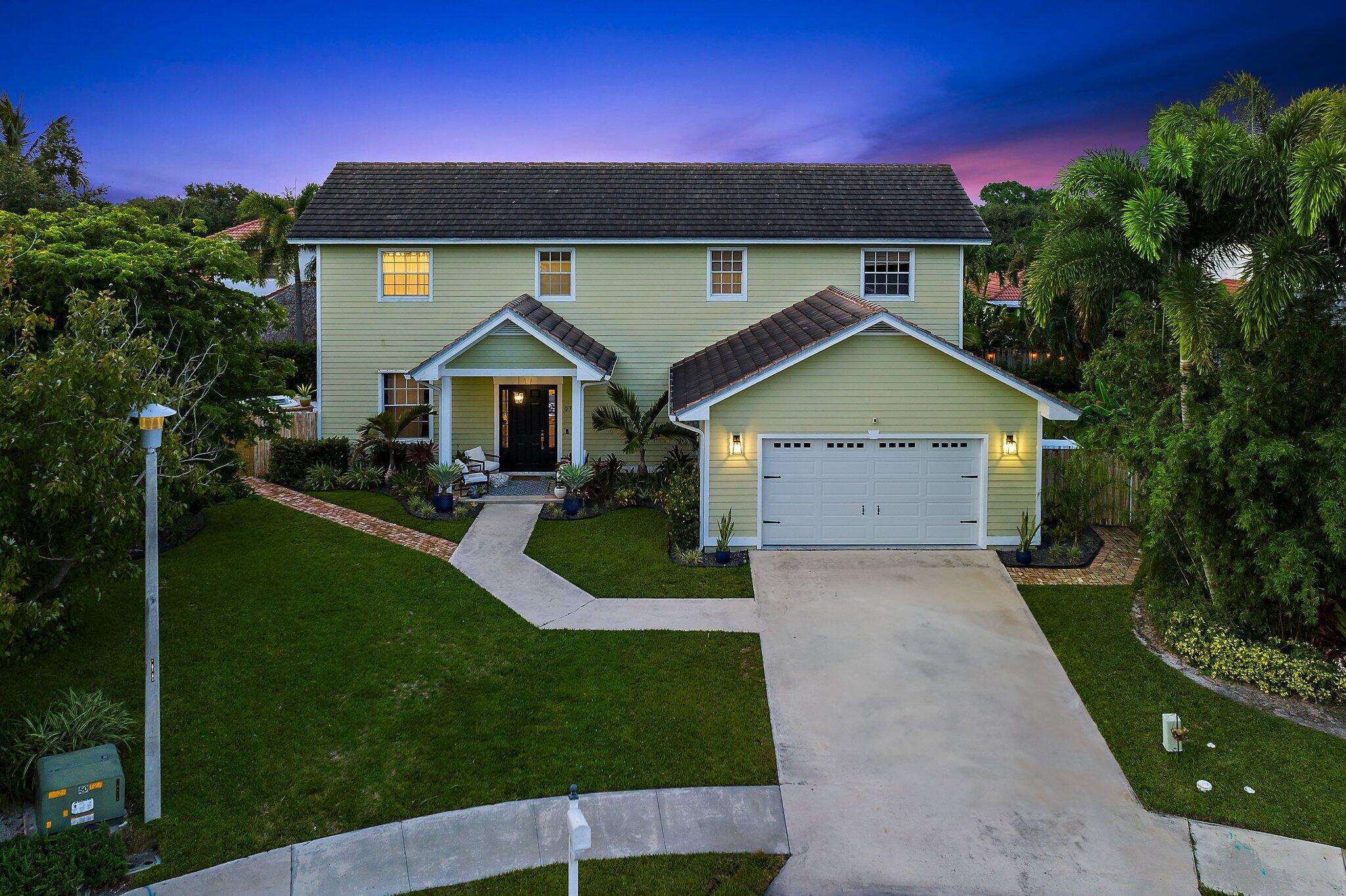 97 Beechwood Trail Tequesta, FL 33469 - Photo 14 of 113 a front view of a house with a yard