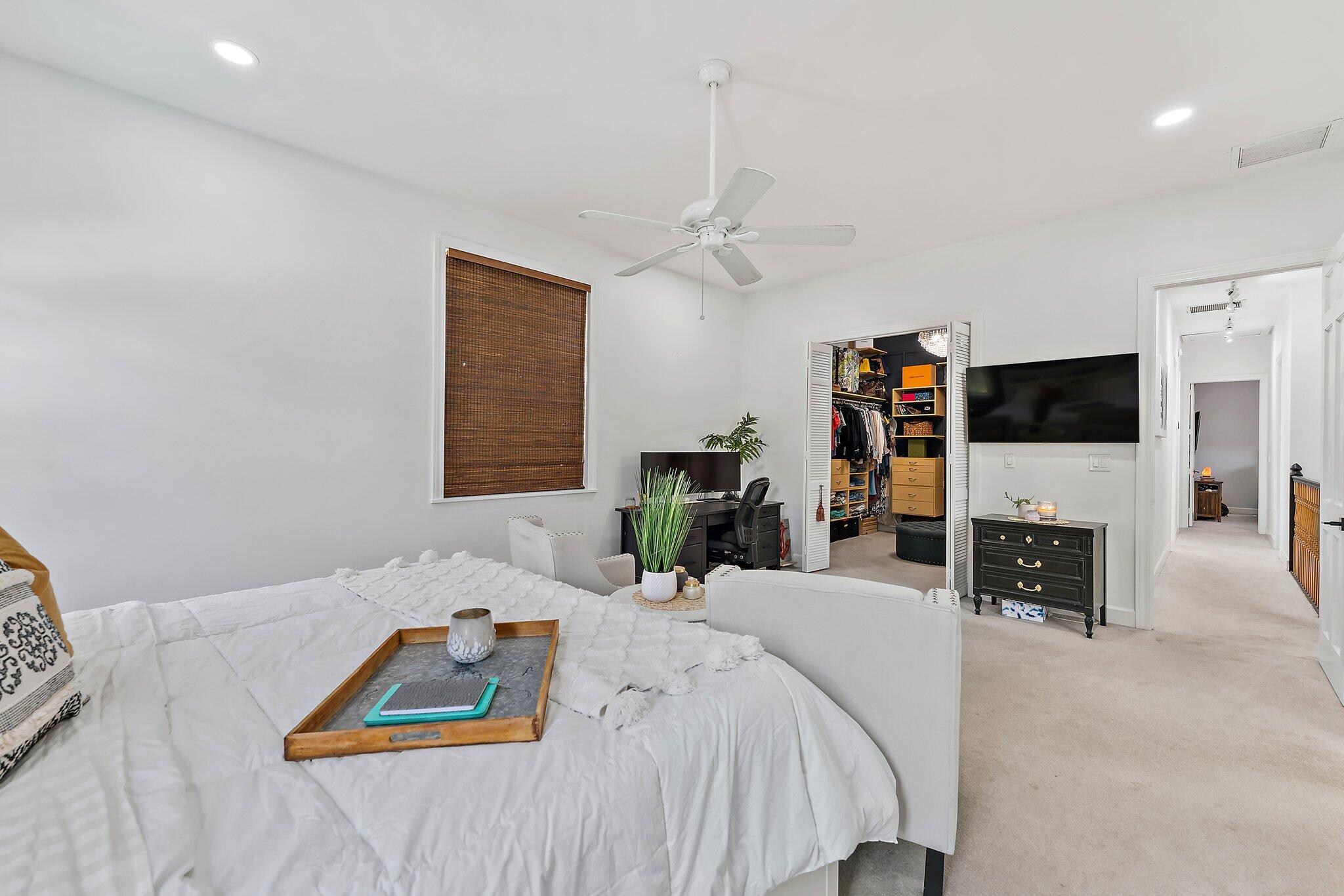 97 Beechwood Trail Tequesta, FL 33469 - Photo 89 of 113 a bedroom with a bed and a flat screen tv