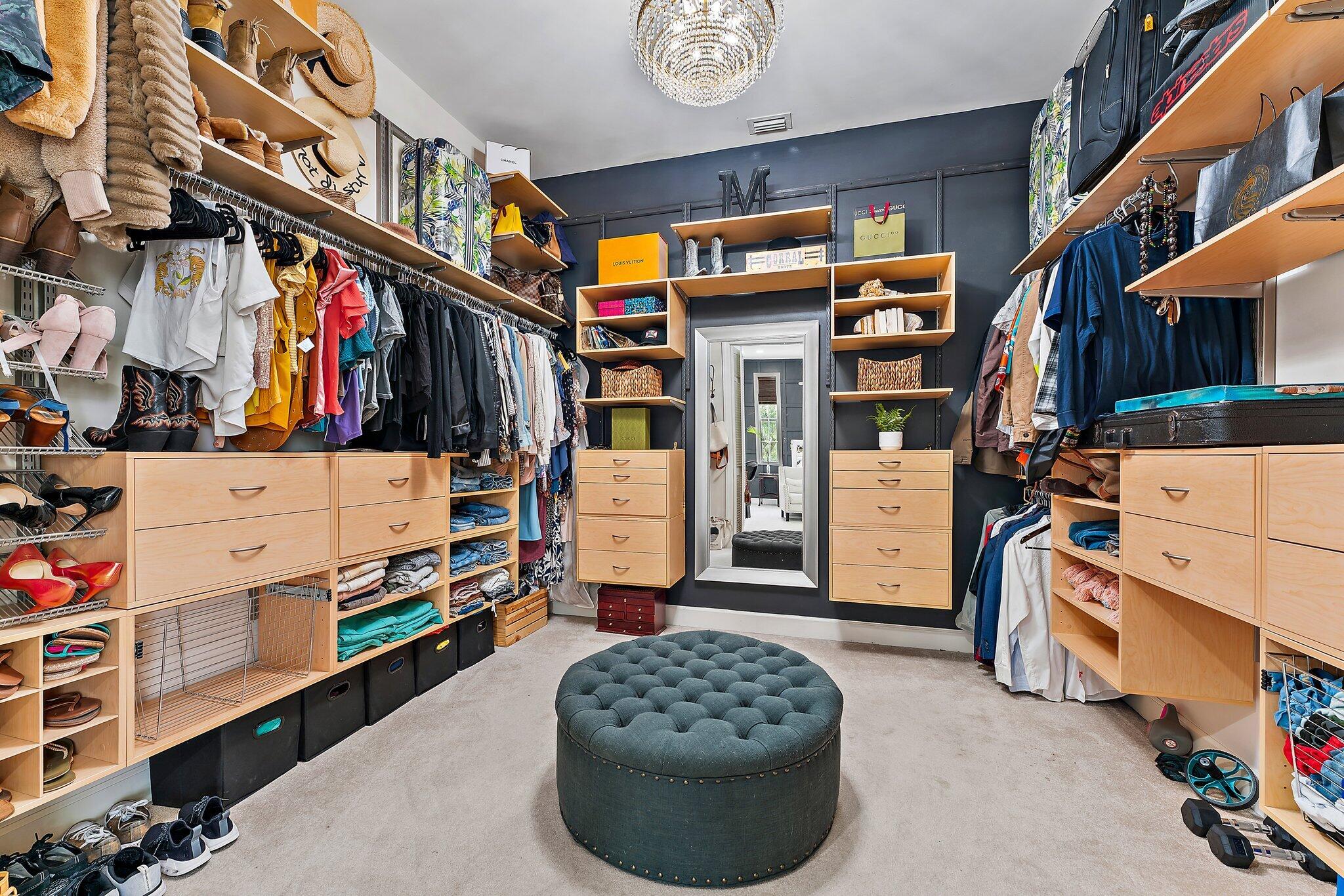 97 Beechwood Trail Tequesta, FL 33469 - Photo 91 of 113 a view of walk in closet with clothes and shoes