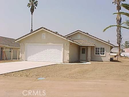 a view of a house with a yard and garage