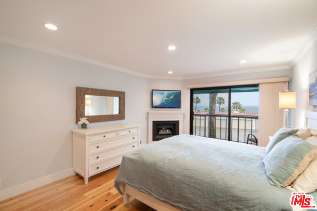 26664 Seagull Way, Unit A105 Malibu, CA 90265 - Photo 13 of 23 a bed room with a bed and a tv