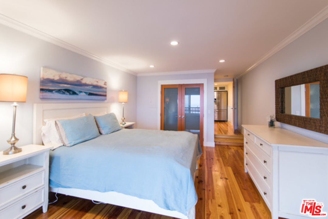 26664 Seagull Way, Unit A105 Malibu, CA 90265 - Photo 14 of 23 a bed room with a bed and a dresser