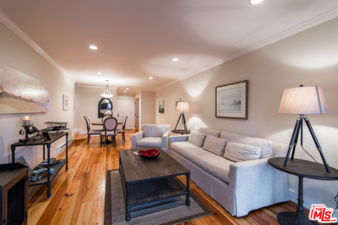 26664 Seagull Way, Unit A105 Malibu, CA 90265 - Photo 2 of 23 a living room with furniture and a lamp