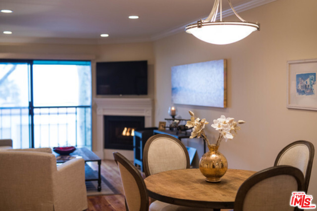 26664 Seagull Way, Unit A105 Malibu, CA 90265 - Photo 4 of 23 a living room with furniture a flat screen tv and a fireplace