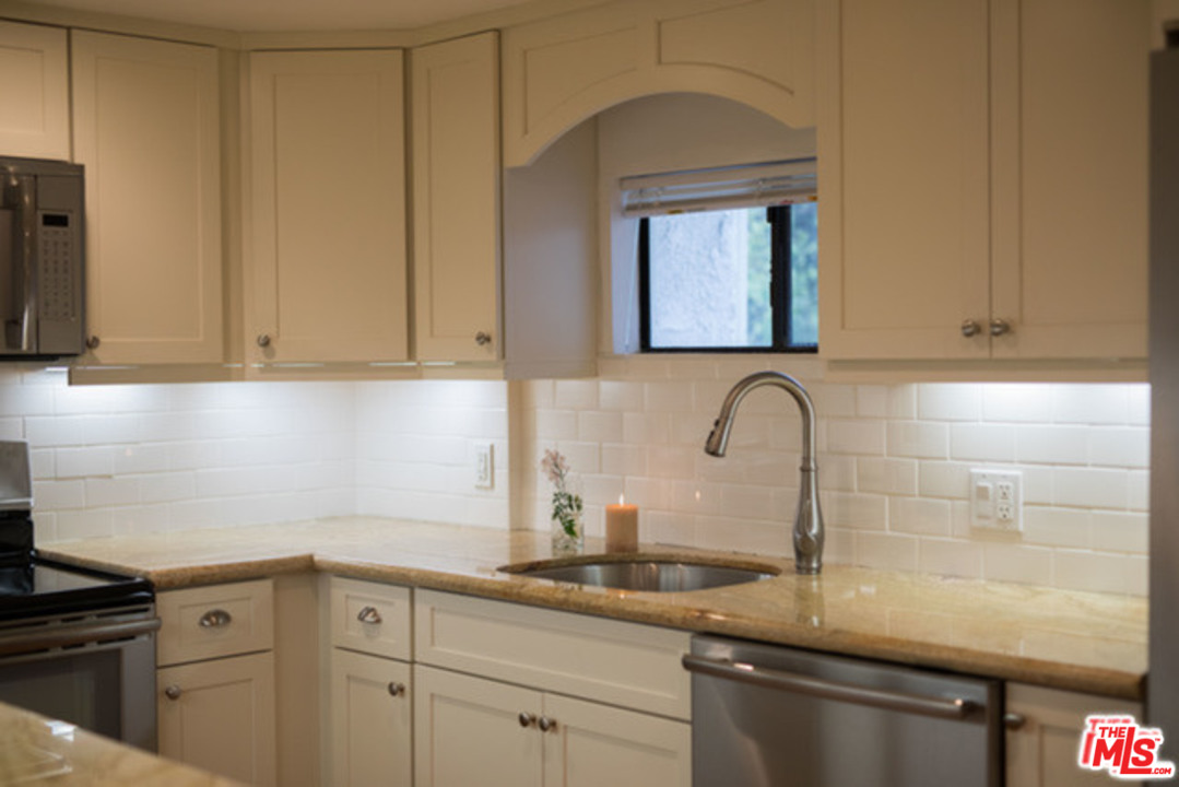 26664 Seagull Way, Unit A105 Malibu, CA 90265 - Photo 9 of 23 a kitchen with sink a window and cabinets