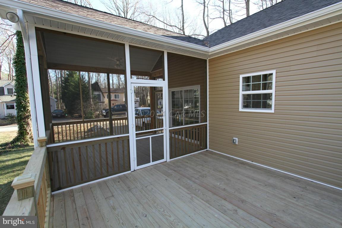 40 Capetown Road Ocean Pines, MD 21811 - Photo 14 of 23 a view of backyard with deck and floor to ceiling window