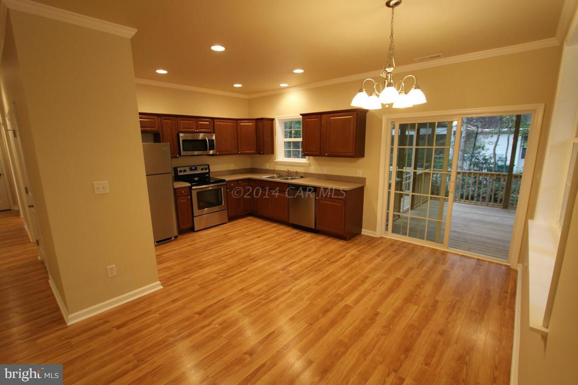 40 Capetown Road Ocean Pines, MD 21811 - Photo 3 of 23 a large kitchen with a refrigerator a stove top oven a sink and dishwasher