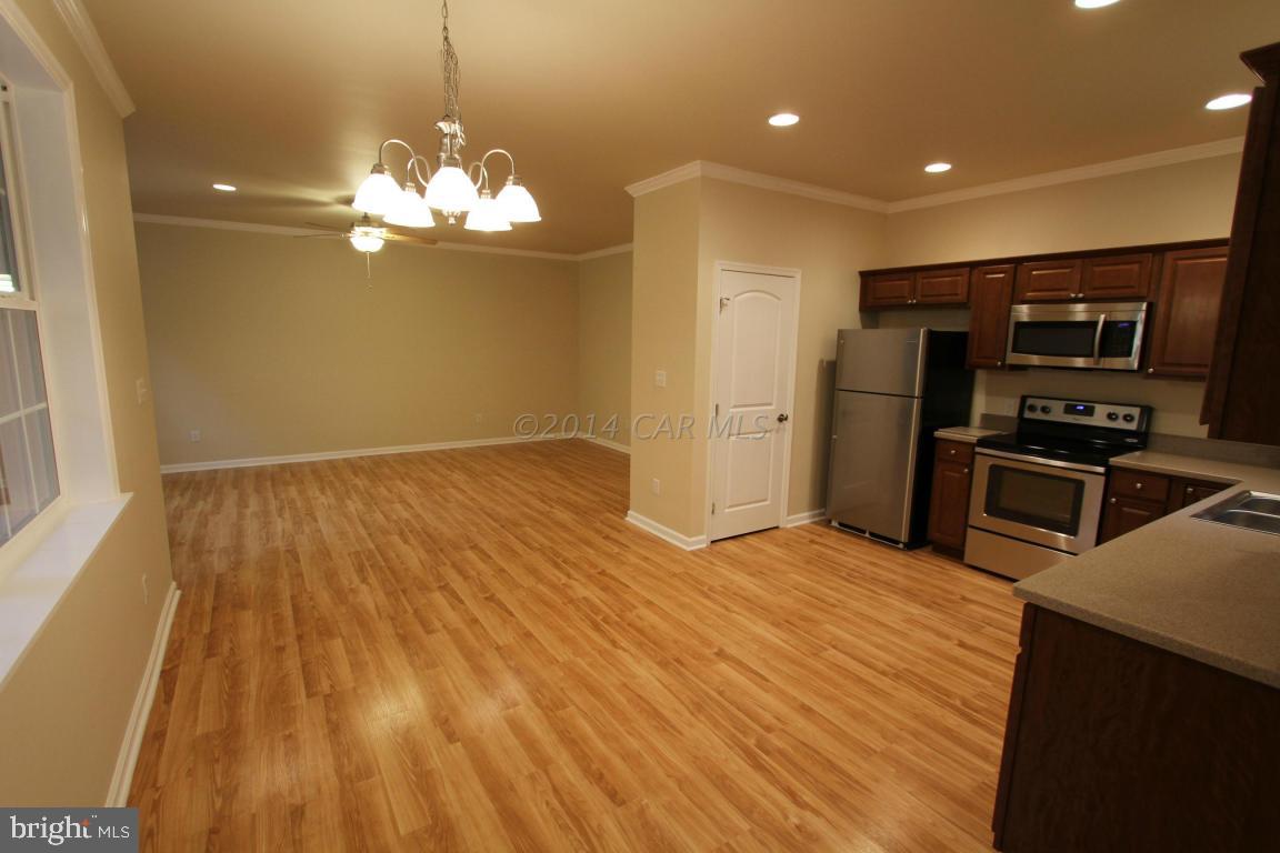 40 Capetown Road Ocean Pines, MD 21811 - Photo 4 of 23 a kitchen with stainless steel appliances granite countertop a refrigerator a stove and a wooden floors