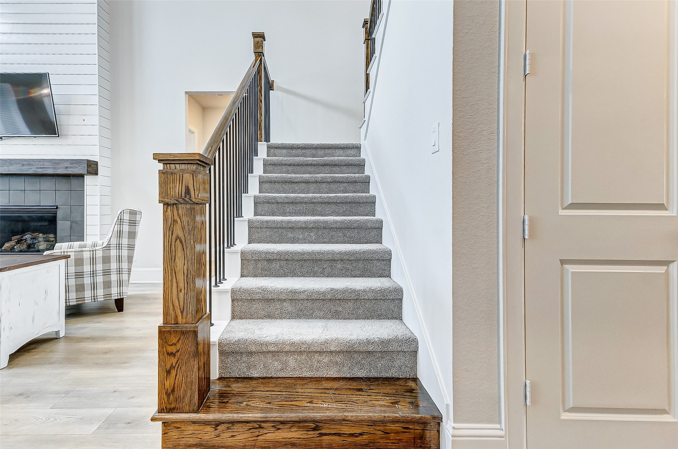 5318 Streamside Trail Fulshear, TX 77441 - Photo 22 of 43 Ascend the plush carpeted stairs, where a wooden rail with wrought iron spindles guides the way to the second floor.
