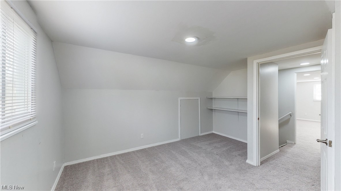 1466 Scenic Way Akron, OH 44310 - Photo 22 of 35 Unfurnished bedroom with a closet, light colored carpet, and vaulted ceiling