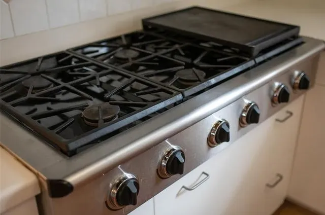 a close up of a stove top oven sitting inside of a kitchen