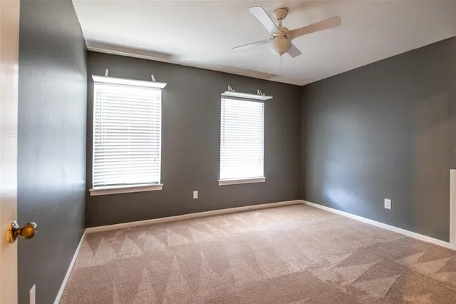 a view of a livingroom with a ceiling fan and window