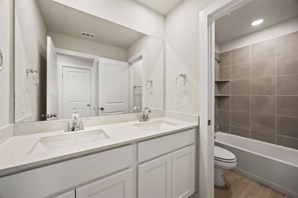 1017 Verde Creek Crowley, TX 76036 - Photo 13 of 20 a bathroom with a sink a toilet and shower