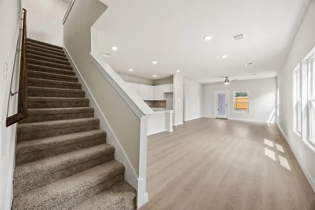 a view of entryway and hall with wooden floor